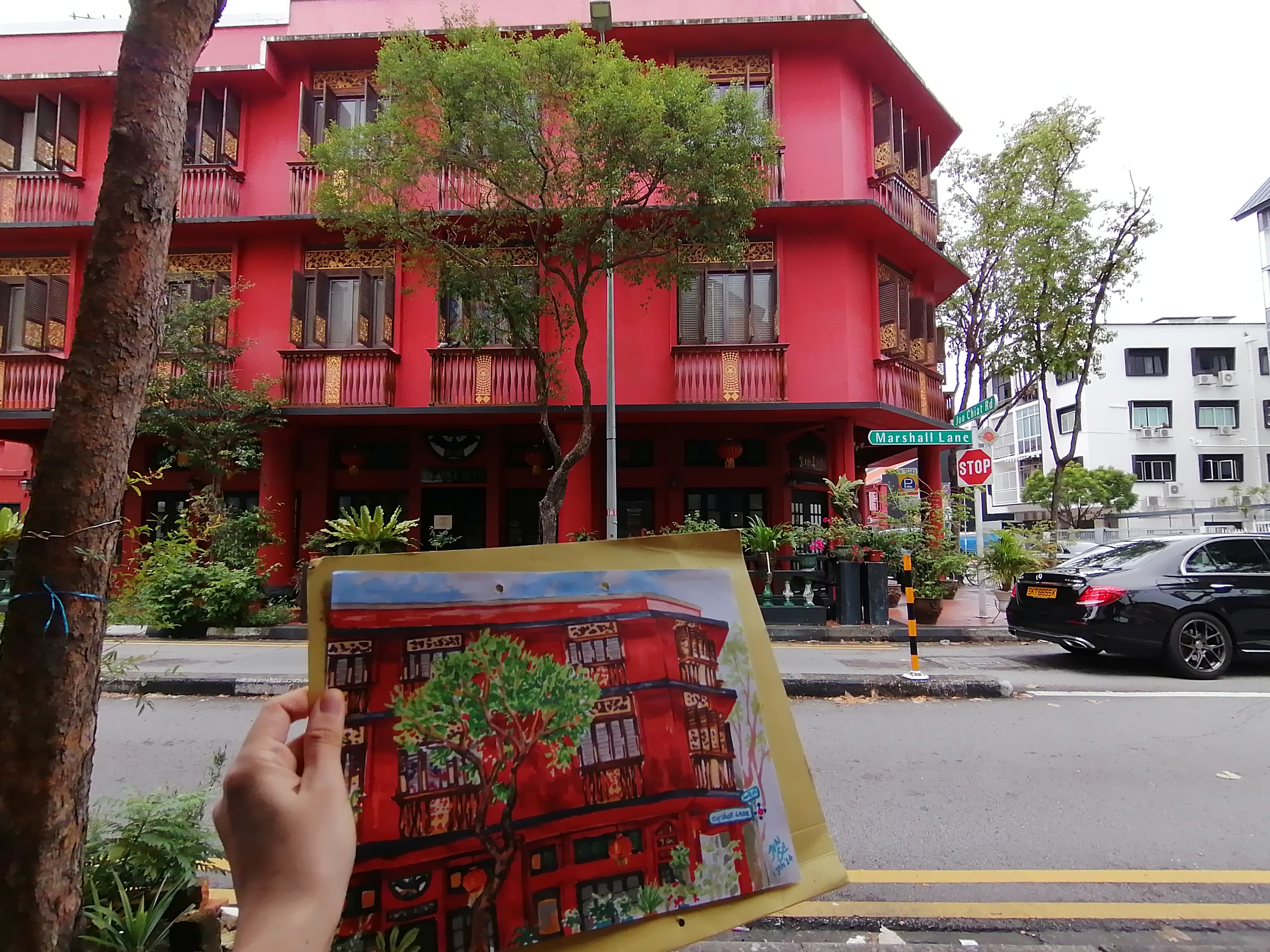 Photo of sketch against the actual building